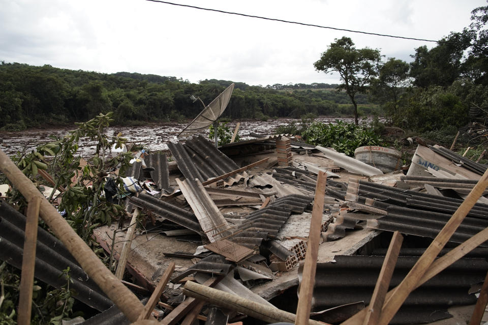 A destroyed house is seen after a dam collapse near Brumadinho, Brazil, Saturday, Jan. 26, 2019. Rescuers in helicopters searched for survivors while firefighters dug through mud in a huge area in southeastern Brazil buried by the collapse of a dam holding back mine waste, with at least nine people dead and up to 300 missing. (AP Photo/Leo Correa)