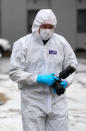 A forensic officer at the scene on Russell Way in Crawley, West Sussex, after a 24-year-old man was fatally stabbed on Tuesday night.