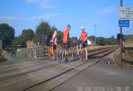 Shocking CCTV footage has been released which shows people risking their lives on level crossings - including a father and his young daughter posing for a photo shoot. The reckless father can be seen taking pictures of the little girl - who appears to be of primary school age - in different directions on the crossing. Their car can be seen in the background with its doors open as the youngster adopts various poses and occasionally looks behind her for approaching trains. Another shocking clip captured on CCTV shows a group of cyclists who dismount their bikes and line up for a group photo on the crossing.