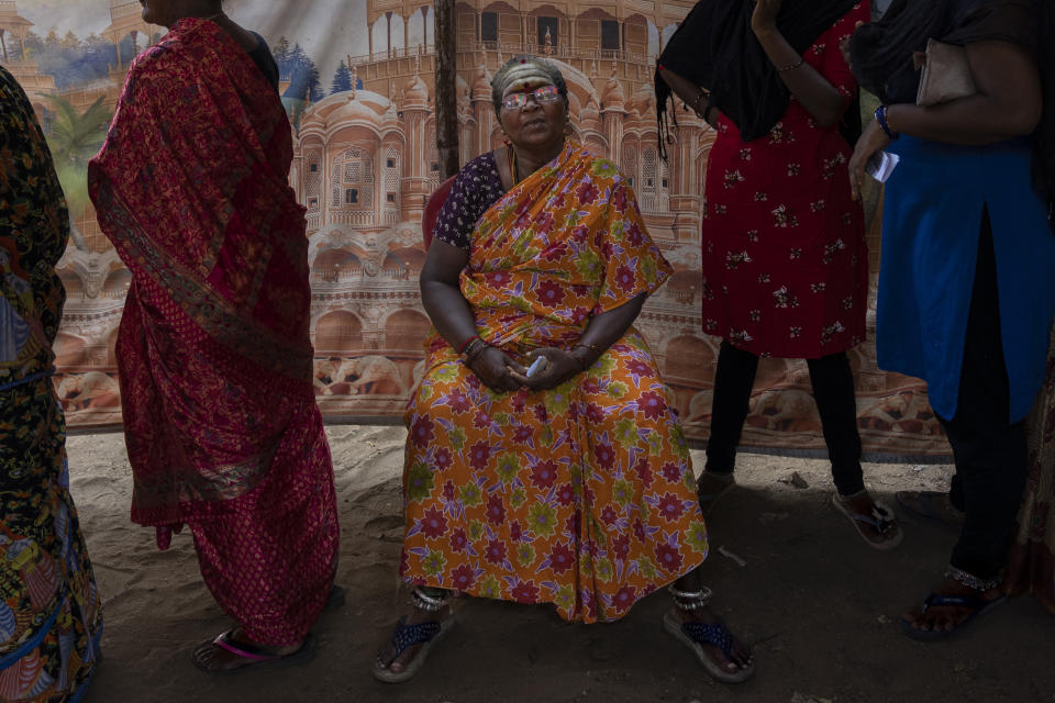 An elderly woman sits on a chair as people wait to cast their votes during the first round of polling of India's national election in Chennai, southern Tamil Nadu state, Friday, April 19, 2024. Nearly 970 million voters will elect 543 members for the lower house of Parliament for five years, during staggered elections that will run until June 1. (AP Photo/Altaf Qadri)