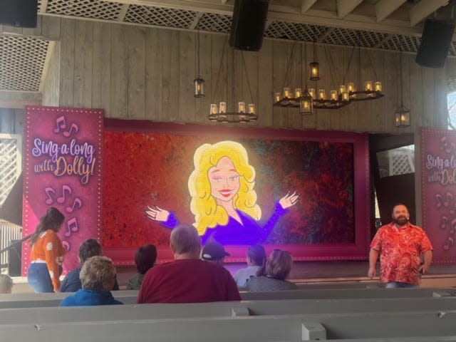 A cartoon of Dolly Parton on a big screen.