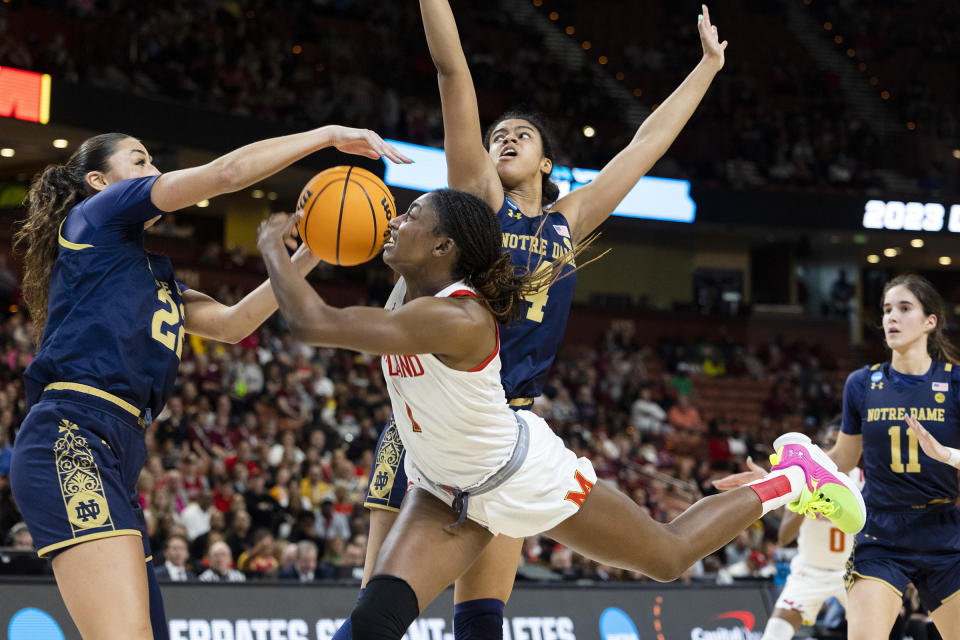 Maryland's Diamond Miller (1) drives to the basket as Notre Dame's Maddy Westbeld (22) and Cassandre Prosper (4) defend in the first half of a Sweet 16 college basketball game of the NCAA Tournament in Greenville, S.C., Saturday, March 25, 2023. (AP Photo/Mic Smith)