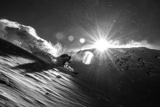 The wind can hit hard in the alpine. Chad Sayers turns through the light on a biting cold day.<p>Photo: Guy Fattal</p>