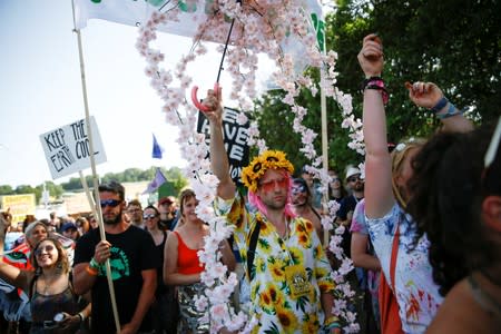 Protestors affiliated with Extinction Rebellion take part in a procession during Glastonbury Festival at Worthy farm in Somerset