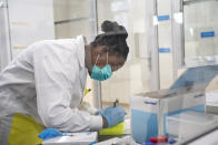 Medical scientist Melva Mlambo, works in sequencing COVID-19 omicron samples at the Ndlovu Research Center in Elandsdoorn, South Africa Wednesday Dec. 8, 2021. The centre ls part of the Network for Genomic Surveillance in South Africa, which discovered the omicron variant. (AP Photo/Jerome Delay)