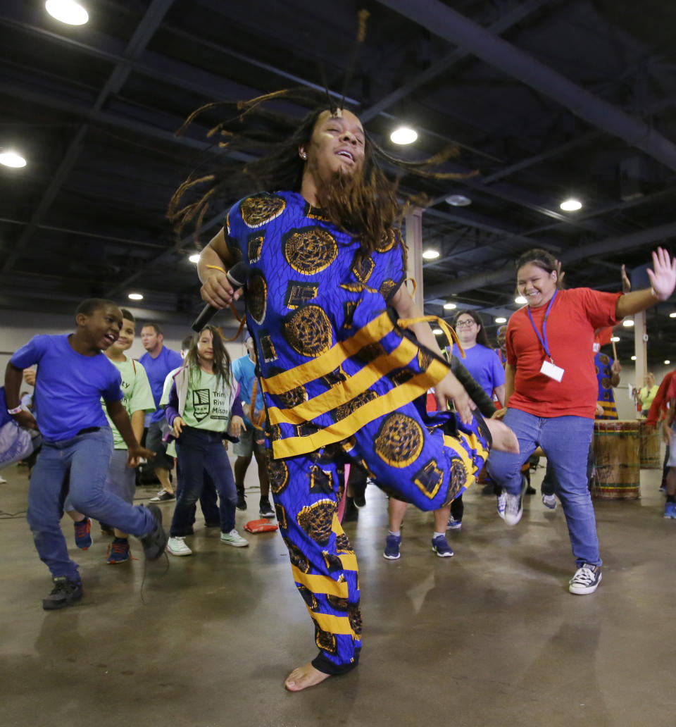 FILE - In this June 19, 2017, file photo, T.J. with the Bandan Koro African Dance Ensemble leads children dancing during a Juneteenth celebration at Fair Park in Dallas. Juneteenth celebration started with the freed slaves of Galveston, Texas. Although the Emancipation Proclamation freed the slaves in the South in 1863, it could not be enforced in many places until after the end of the Civil War in 1865. (AP Photo/LM Otero, File)