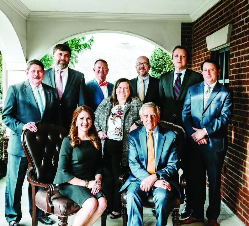 The attorneys of the Clardy Law Firm in Greenville: standing, from left, David Hill Keller, Andrew F. Carson, Allen Clardy, David Hartman, Tim Nowacki, Brad B. Easterling; seated, Genevieve Mendes Weaver, Dana M. Lahey and John Creech.