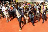 Residents carry the Ethiopian and Eritrean national flags as they dance during a concert at the Millennium Hall in Addis Ababa, Ethiopia July 15, 2018. REUTERS/Tiksa Negeri