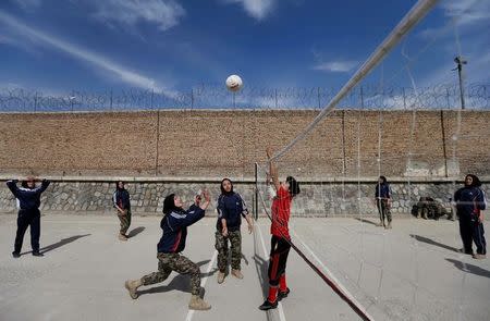 Female soldiers from the Afghan National Army (ANA) play volleyball at the Kabul Military Training Centre (KMTC) in Kabul, Afghanistan, October 23, 2016. REUTERS/Mohammad Ismail