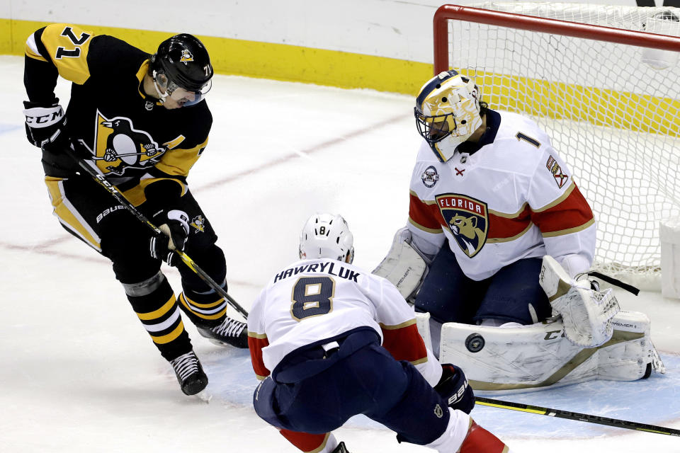 Pittsburgh Penguins' Evgeni Malkin (71) can't get a shot past Florida Panthers goaltender Roberto Luongo (1) during the first period of an NHL hockey game in Pittsburgh, Tuesday, March 5, 2019. (AP Photo/Gene J. Puskar)