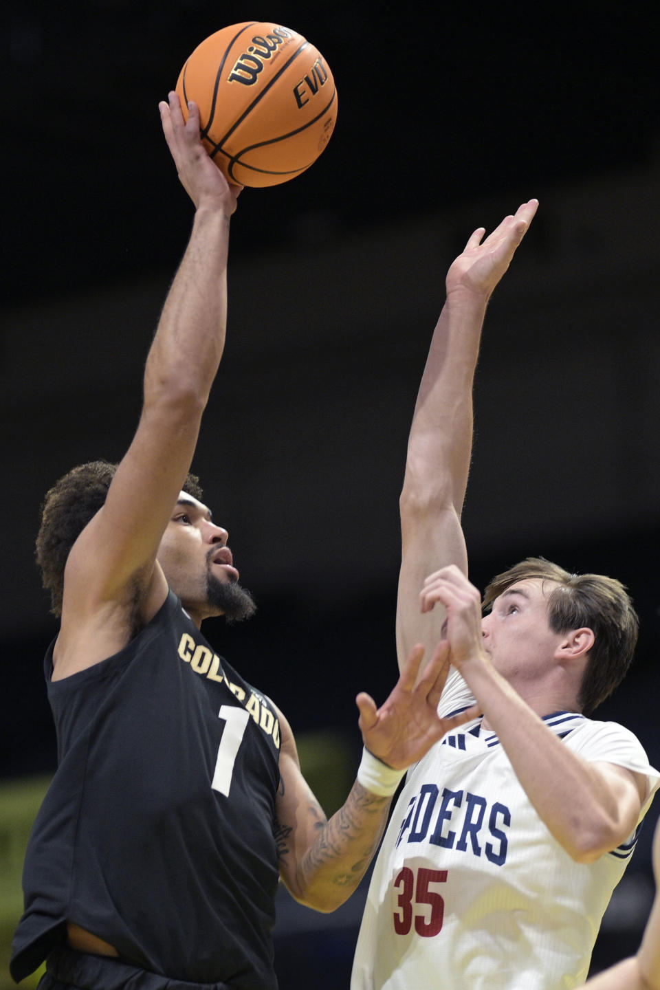 Colorado guard J'Vonne Hadley (1) shoots in front of Richmond forward Aidan Noyes (35) during the first half of an NCAA college basketball game, Monday, Nov. 20, 2023, in Daytona Beach, Fla. (AP Photo/Phelan M. Ebenhack)