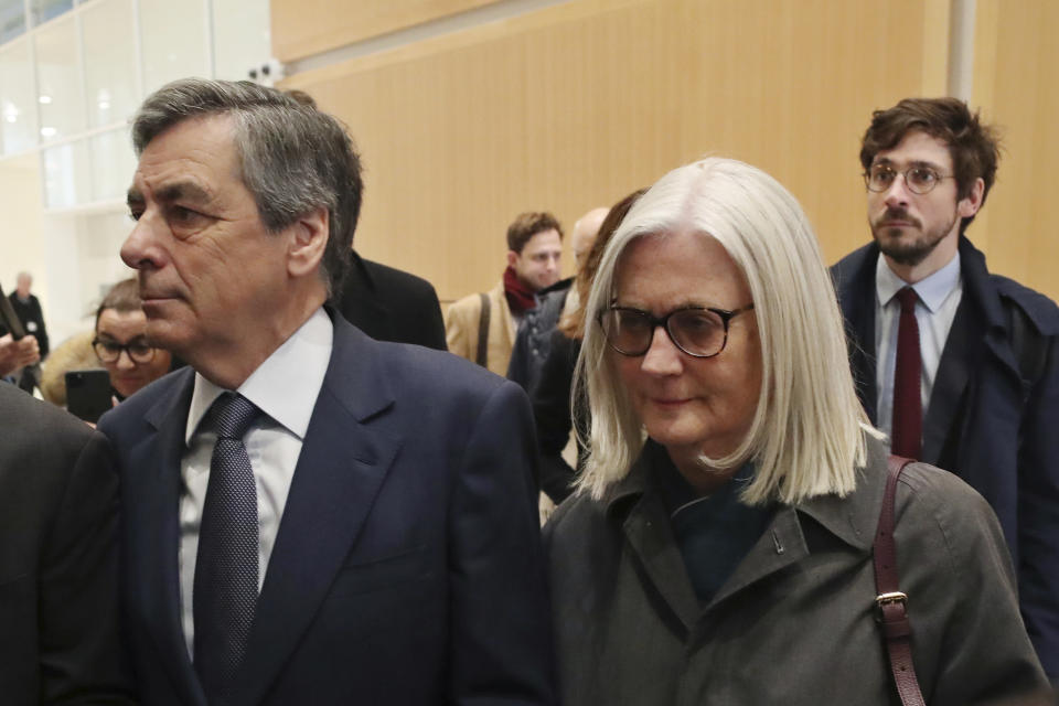 France's former Prime Minister Francois Fillon, left, and his wife Penelope, arrive at the Paris courthouse, in Paris, Wednesday, Feb. 26, 2020. He could have been president of France. Instead, former Prime Minister Francois Fillon is going on trial to face fraud charges after he used public funds to richly pay his wife and children for work they allegedly never performed. (AP Photo/Thibault Camus)