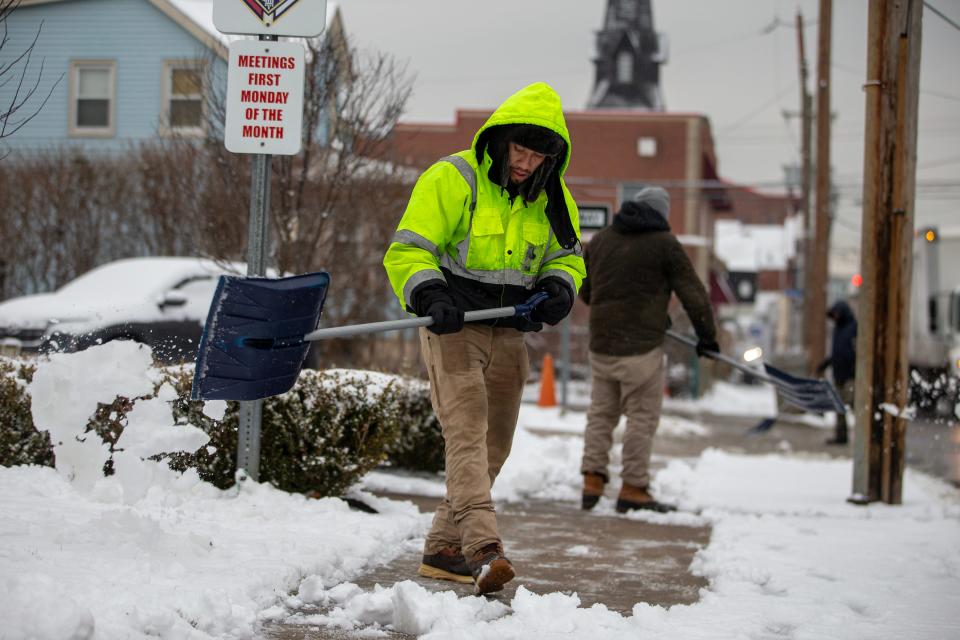 Francisco Lopez of Old Bridge shovels snow from the sidewalk in front of Our Lady of Fatima on Broad Street in Keyport, NJ Tuesday January 16, 2024.