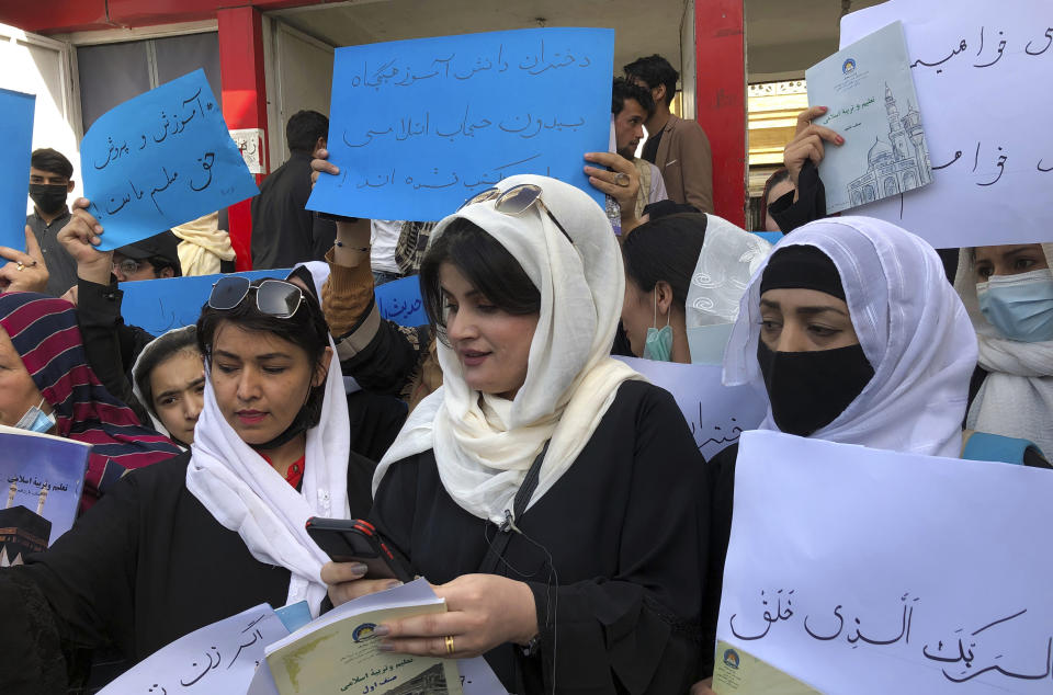 Afghan women chant and hold signs to protest during a demonstration in Kabul, Afghanistan, Saturday, March 26, 2022. Afghanistan's Taliban rulers refused to allow dozens of women to board several flights, including some overseas, because they were traveling without a male guardian, two Afghan airline officials said Saturday. (AP Photo/Mohammed Shoaib Amin)