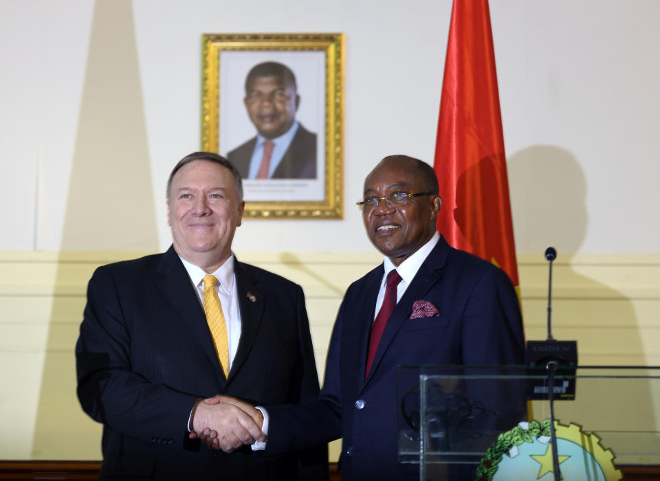 US Secretary of State, Mike Pompeo, left, and Angola Foreign Minister, Manuel Domingos Augusto hold a press conference in Luanda, Angola, Monday Feb. 17, 2020. Pompeo started his tour of Africa in Senegal, the first U.S. Cabinet official to visit in more than 18 months. He left Senegal Sunday to arrive in Angola and will then travel on to Ethiopia as the Trump administration tries to counter the growing interest of China, Russia and other global powers in Africa and its booming young population of more than 1.2 billion. (Andrew Caballero-Reynolds/Pool via AP)