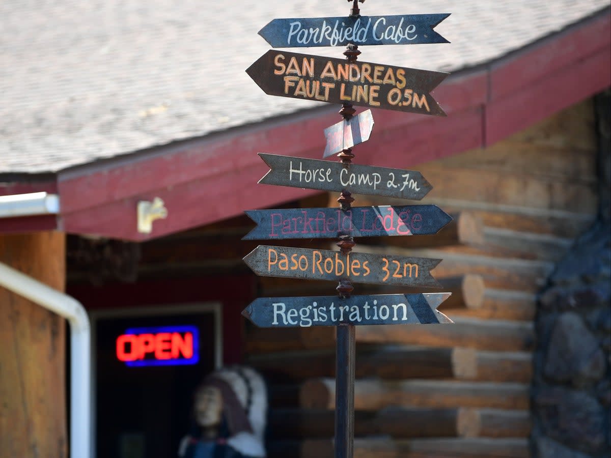 A signpost in front of the Parkfield Cafe offers information and directions to various places, including the nearby San Andreas Fault which runs under the small population town of Parkfield on July 12, 2019 (AFP via Getty Images)