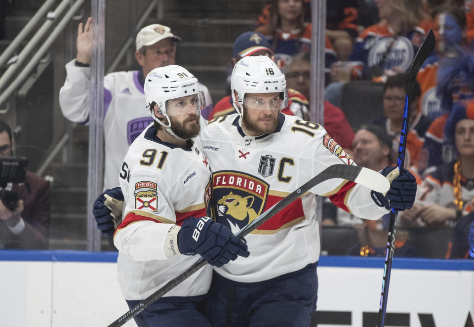 Florida Panthers' Oliver Ekman-Larsson (91) and Aleksander Barkov (16) celebrate after a goal against the Edmonton Oilers during the third period of Game 6 of the NHL hockey Stanley Cup Final, Friday, June 21, 2024, in Edmonton, Alberta. (Jason Franson/The Canadian Press via AP)