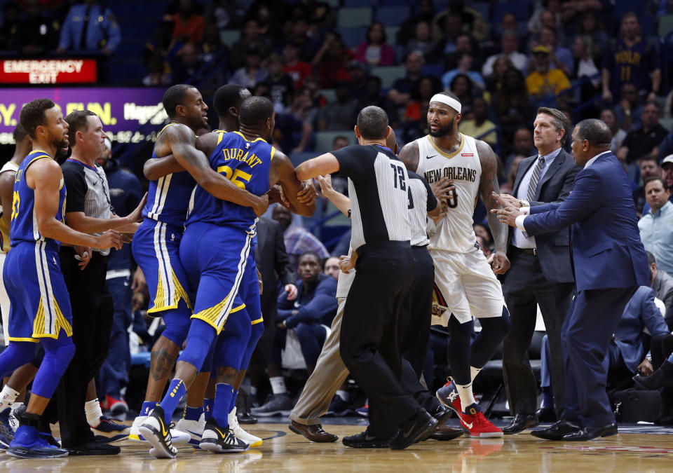 Kevin Durant gets “held back” by teammates and earns an ejection. (AP Photo/Gerald Herbert)