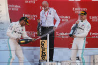 FILE PHOTO: Formula One F1 - Spanish Grand Prix - Circuit de Barcelona-Catalunya, Barcelona, Spain - May 12, 2019 First placed Mercedes' Lewis Hamilton and second placed Mercedes' Valtteri Bottas with Chairman of the Board of Management of Mercedes Benz Dieter Zetsche on the podium. REUTERS/Jon Nazca