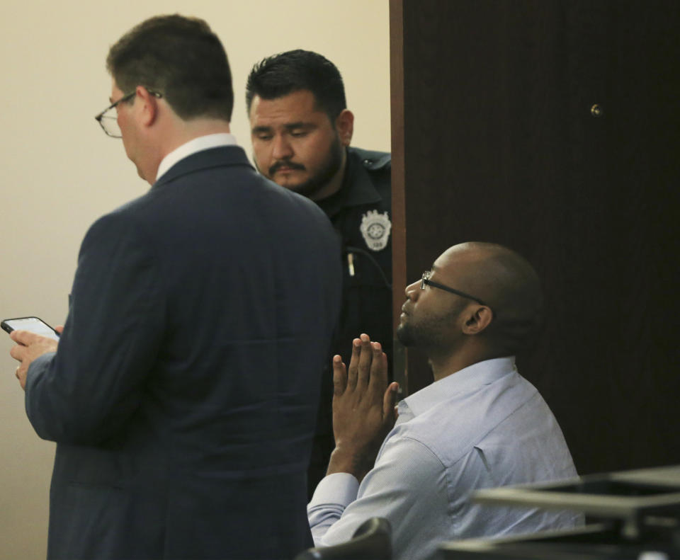 Otis McKane clasps his hands together right before he elbowed a bailiff who was attempting to handcuff him after the jury delivered a guilty verdict in his capital murder trial for the shooting of San Antonio police detective Benjamin Marconi on Monday, July 26, 2021, in San Antonio. (Kin Man Hui/The San Antonio Express-News via AP)