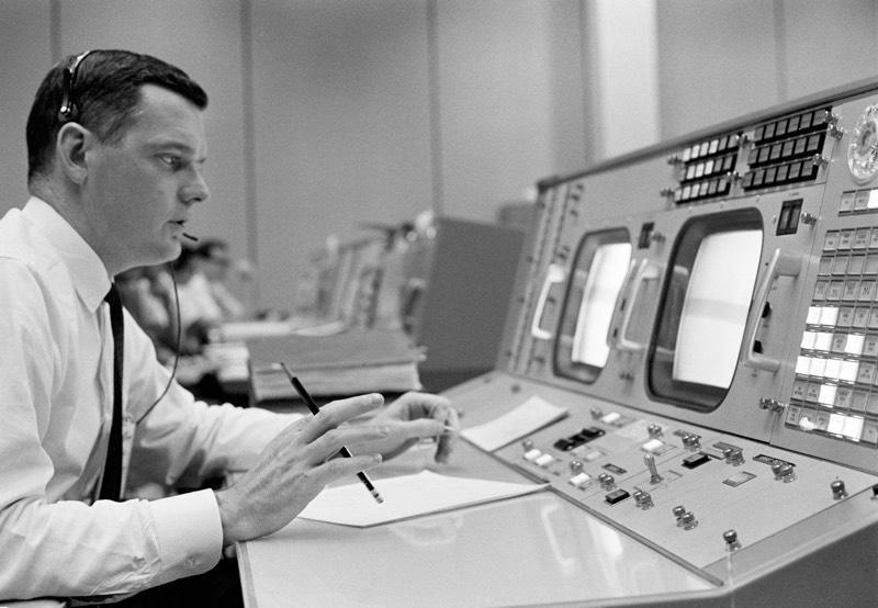 Lunney, sitting at his console in mission control. / Credit: NASA