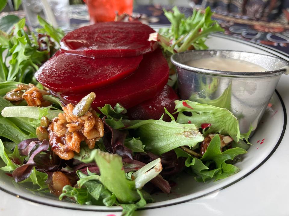 One of the restaurant's most popular menu items is its pickled beet salad, which comes with mixed greens, candied nuts, goat cheese (not shown) and, of course, pickled beets made in-house. A side of vegan French white dressing accompanies this sensational salad.