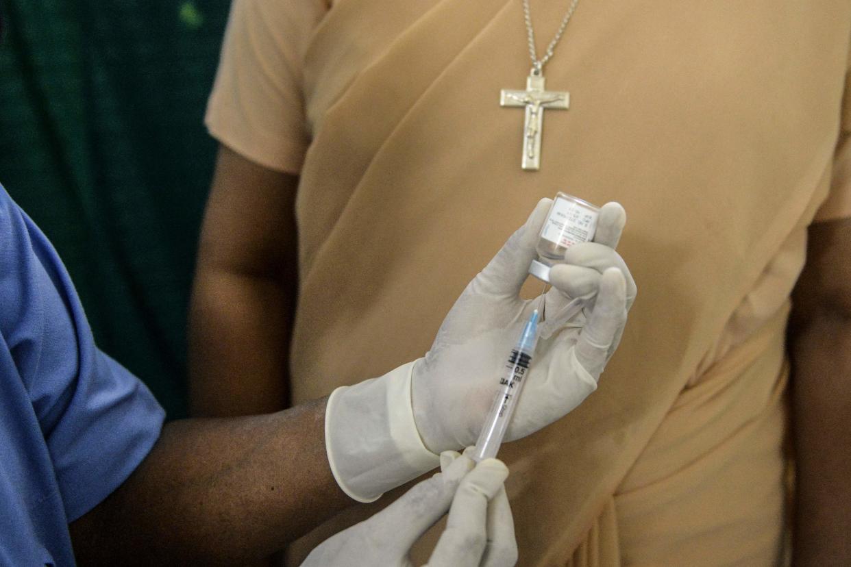 A health worker prepares to inoculate a nun with a dose of the ‘Covaxin’ vaccine against Covid-19 (AFP via Getty Images)