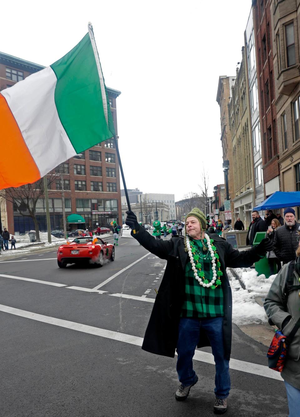 Terry King of Milwaukee dances in the street to the Irish music along Plankinton Avenue during the St. Patrick's Day parade in downtown Milwaukee in 2019. The 2020 and 2021 downtown parades were canceled because of the COVID-19 pandemic.