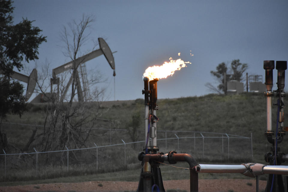 FILE - A flare to burn methane from oil production is seen on a well pad near Watford City, N.D., on Aug. 26, 2021. Oil and gas companies will have to pay more to drill on public lands and satisfy stronger requirements to clean up old or abandoned wells under a final rule issued Friday, April 12, 2024, by the Biden administration. The Interior Department rule does not go so far as to prohibit new oil and gas leasing on public lands, as many environmental groups have urged and as President Joe Biden promised during the 2020 campaign. (AP Photo/Matthew Brown, File)