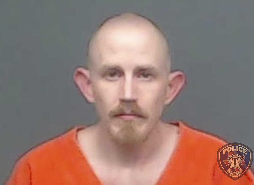 In this image provided by the Texarkana, Texas, Police Department, Aaron Swenson is seen in his police booking photo. The 36-year-old Arkansas man whose Facebook page included “boogaloo” references was arrested on April 11 by police in Texarkana, Texas, on a charge he threatened to ambush and kill a police officer on a Facebook Live video. It's a fringe movement with roots in a online meme culture steeped in irony and dark humor. But experts warn that the anti-government “boogaloo” movement has attracted a dangerous element of far-right extremists. (Texarkana Police Department via AP)