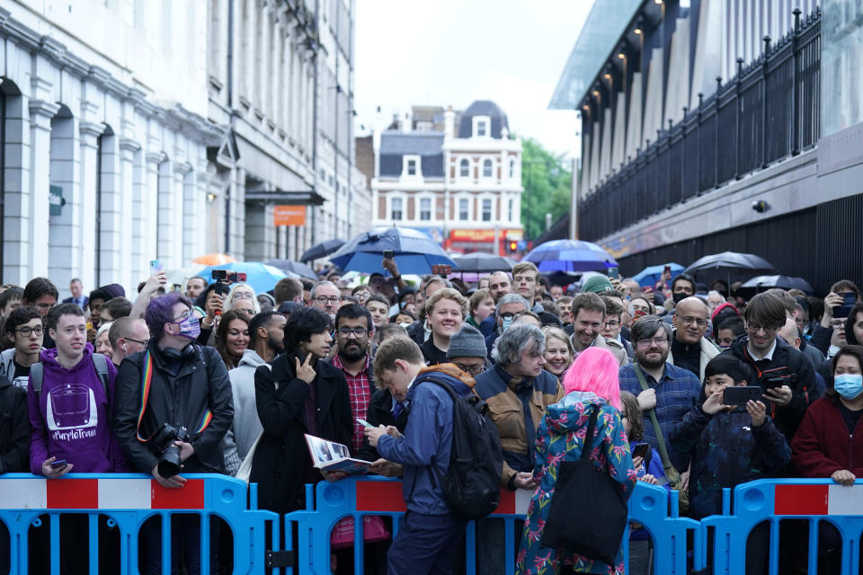 Crowds wait in line to board the first Elizabeth line train to carry passengers at Paddington Station, London. The delayed and overbudget line will boost capacity and cut journey times for east-west travel across the capital. Picture date: Tuesday May 24, 2022.