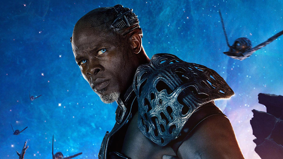 Djimon Hounsou with blue eyes and in armor on the poster of Guardians of the Galaxy.