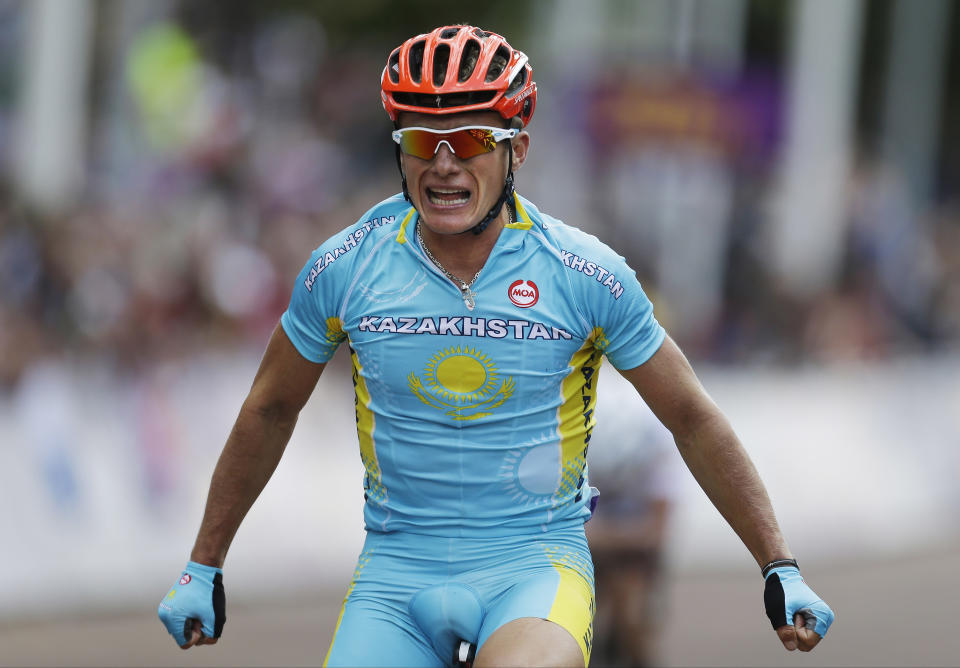 FILE - In this July 28, 2012 file photo Kazakhstan's Alexandre Vinokourov celebrates as he crosses the finish line to win the Men's Road Cycling race at the 2012 Summer Olympics, Saturday, July 28, 2012, in London. Extending the fallout from the Lance Armstrong doping report, at least 15 more cyclists are being linked to the American's banned physician in what is unfolding as an intricate scheme of money laundering, tax evasion and widespread doping. The Gazzetta dello Sport reports that former Giro d'Italia winners Michele Scarponi and Denis Menchov, plus this year's Olympic champion Alexandre Vinokourov, are under investigation for doping under the supervision of Dr. Michele Ferrari. (AP Photo/Sergey Ponomarev, File)