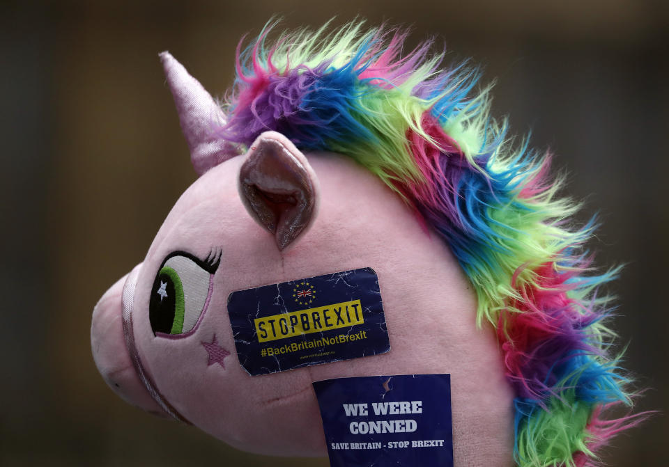 A toy unicorn is photographed during a demonstration opposite the Houses of Parliament as Pro-European demonstrators protest in London, Monday, Jan. 14, 2019. Britain's Prime Minister Theresa May is struggling to win support for her Brexit deal in Parliament. Lawmakers are due to vote on the agreement Tuesday, and all signs suggest they will reject it, adding uncertainty to Brexit less than three months before Britain is due to leave the EU on March 29. (AP Photo/Frank Augstein)