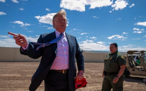 Trump visits a new section of the border wall in Calexico, California - Credit: AP
