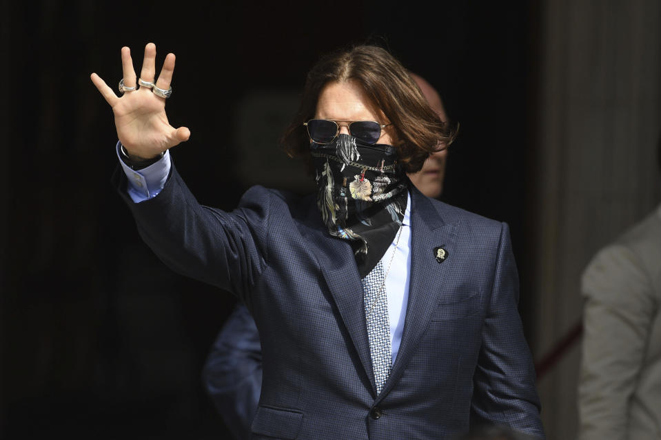 Actor Johnny Depp arrives at the High Court for a hearing in his libel case, in London, Friday, July 24, 2020. Depp is suing News Group Newspapers, publisher of The Sun, and the paper's executive editor, Dan Wootton, over an April 2018 article that called him a "wife-beater." The Sun's defense relies on a total of 14 allegations by his ex-wife, actress Amber Heard of Depp's violence. He strongly denies all of them. (Kirsty O'Connor/PA via AP)