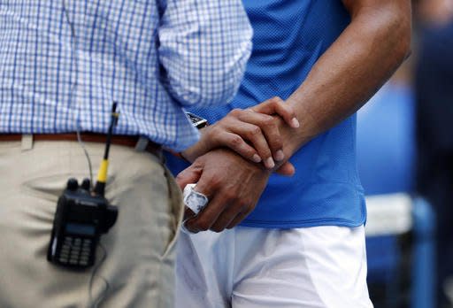 Rafael Nadal, of Spain, holds his left wrist while answering questions after defeating Denis Istomin, of Uzbekistan, during the first round of the U.S. Open tennis tournament, Monday, Aug. 29, 2016, in New York. (AP Photo/Alex Brandon)