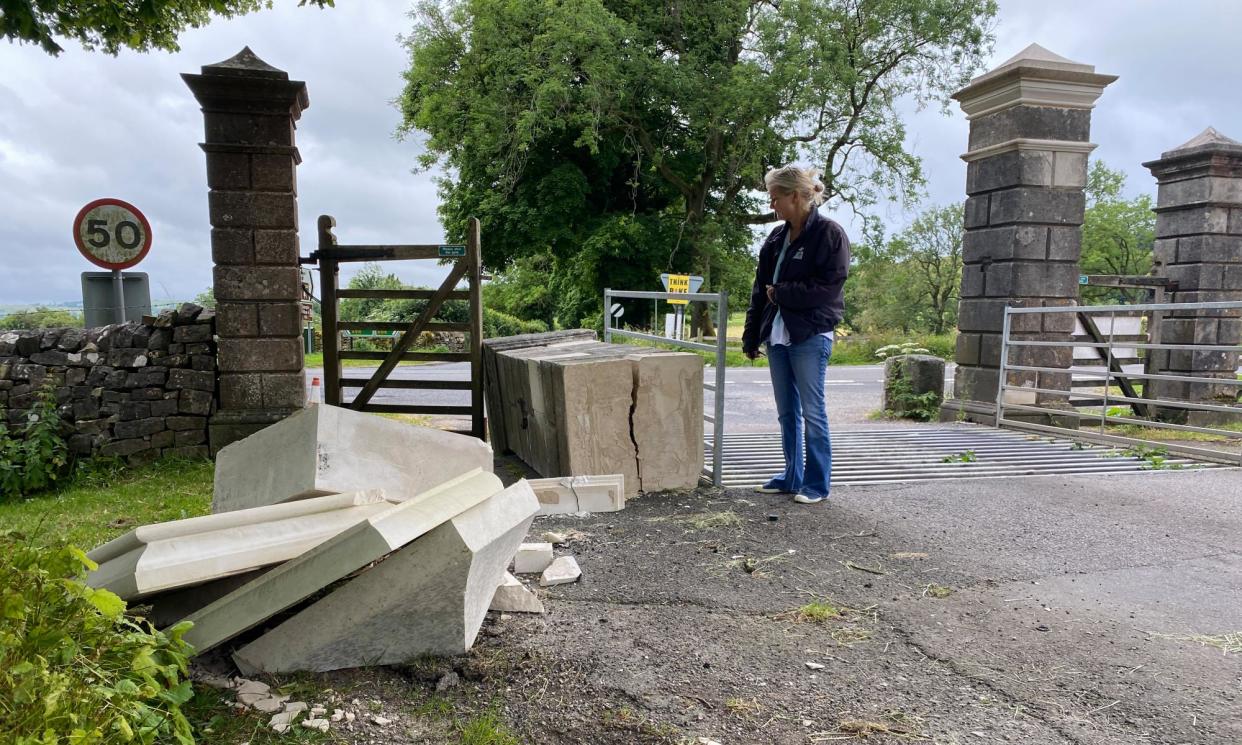 <span>A bystander inspects the latest damage done to the Tissington village gateway.</span><span>Photograph: Sir Richard FitzHerbert</span>