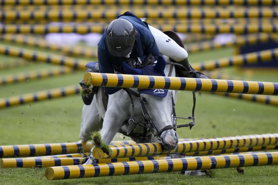 Switzerland's Martin Fuchs on Leone Jesi crashes as he competes in the Six Bars horse jumping competition at Rome's horse show, Saturday, May 28, 2022. (AP Photo/Andrew Medichini)
