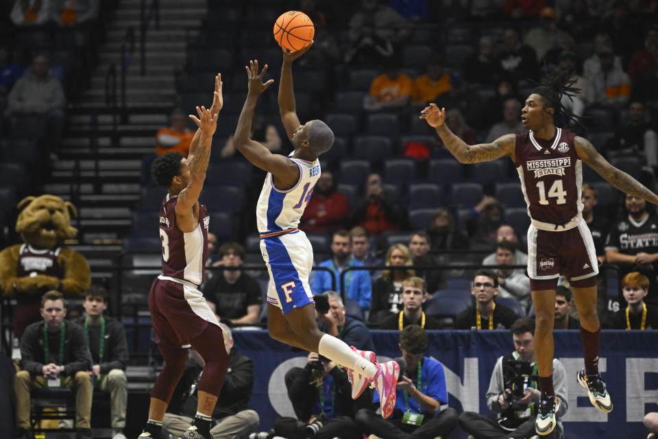 Florida guard Kowacie Reeves shoots as Mississippi State guard Shakeel Moore (3) and forward Tyler Stevenson (14) defend during the first half of an NCAA college basketball game in the second round of the Southeastern Conference Tournament, Thursday, March 9, 2023, in Nashville, Tenn. (AP Photo/John Amis)