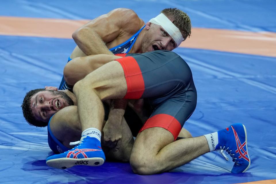 Lansing native Kyle Dake, top, and Zaurbek Sidakov of Russia compete in their men's freestyle 74 kg wrestling final match during the Wrestling World Championships in Belgrade, Serbia on Sept. 18, 2023.