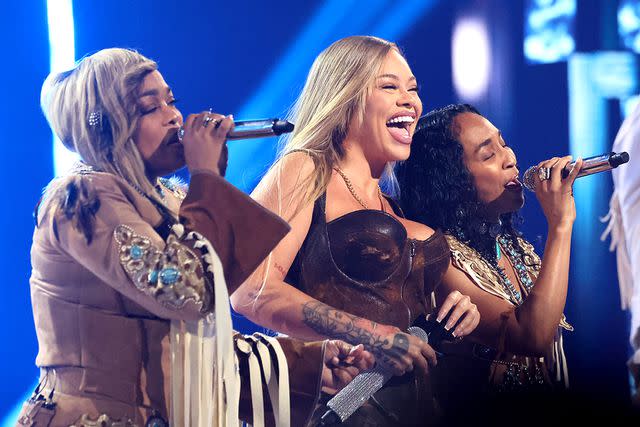 <p>Amy Sussman/Getty</p> Tionne 'T-Boz' Watkins and Rozonda 'Chilli' Thomas of TLC perform with Latto (center) at the iHeartRadio Music Awards in Los Angeles on April 1, 2024