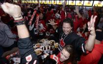 Fans celebrate Team Canada's gold medal win over Sweden in their men's ice hockey game at the Sochi 2014 Winter Olympic Games, at a gathering in Toronto February 23, 2014. REUTERS/Aaron Harris (CANADA - Tags: SPORT OLYMPICS ICE HOCKEY)