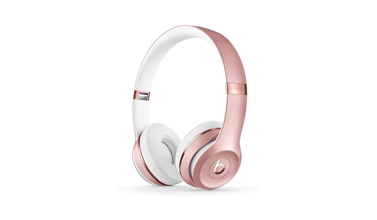 Rose gold and white Beats by Dre over ear wireless headphones