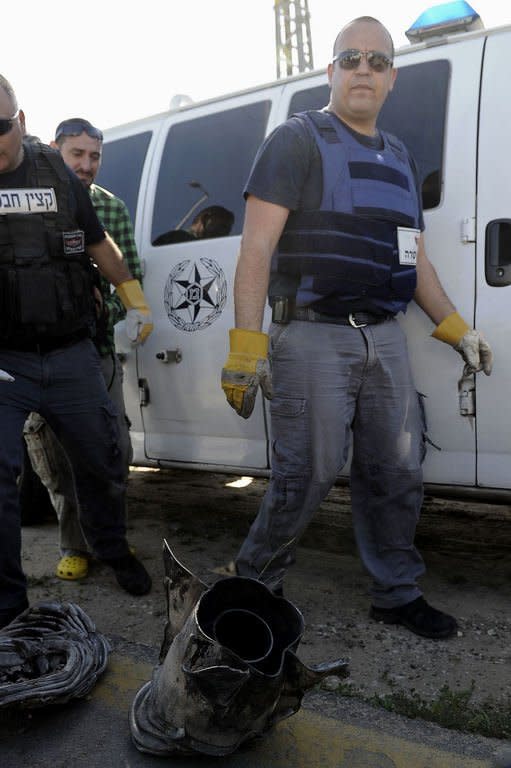 Israeli bomb technicians inspect the remains of a rocket that was fired from the Gaza Strip and landed near the southern city of Ashkelon on February 26, 2013. Gaza militants from Fatah's Al-Aqsa Martyrs Brigades have fired a rocket at Israel in a "preliminary" step after one of its men died following an Israeli interrogation