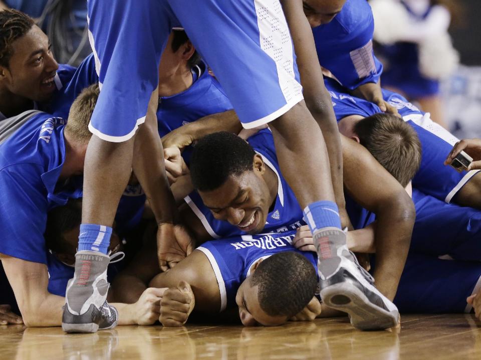 Kentucky players celebrate on the court after their 74-73 victory over Wisconsin in an NCAA Final Four tournament college basketball semifinal game Saturday, April 5, 2014, in Arlington, Texas.(AP Photo/Eric Gay)