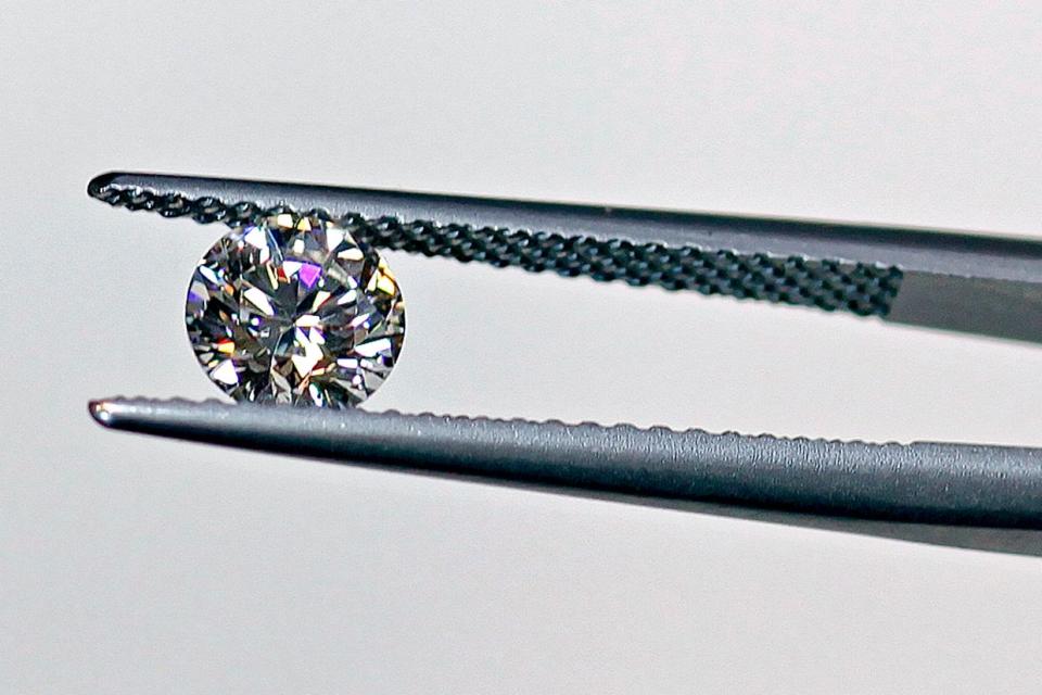 <em>A diamond is held up for examination at a store run by Brilliant Earth, which uses conflict-free diamonds from Canadian mines, in San Francisco, California, U.S., on Friday, June 5, 2009. (Photo by Chip Chipman/Bloomberg via Getty Images)</em>