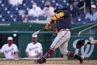 Atlanta Braves' Ronald Acuna Jr. hits a fielder's choice ground ball in the seventh inning of an opening day baseball game against the Washington Nationals at Nationals Park, Tuesday, April 6, 2021, in Washington. Austin Riley scored on the play. (AP Photo/Alex Brandon)