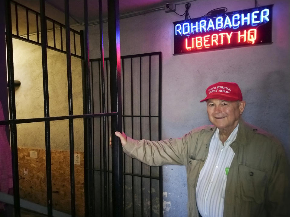 FILE - In this Nov. 6, 2018 file photo, U.S. Rep. Dana Rohrabacher, R-Costa Mesa, leaves the Rohrabacher's "Liberty Headquarters" set upstairs of the Skosh Monahan's Irish Pub in Costa Mesa, Calif. The 15-term Republican Rohrabacher was ousted from his seat. The Southern California county between Los Angeles and San Diego long known as a GOP stronghold now has more registered Democrats than Republicans. (AP Photo/Damian Dovarganes, File)