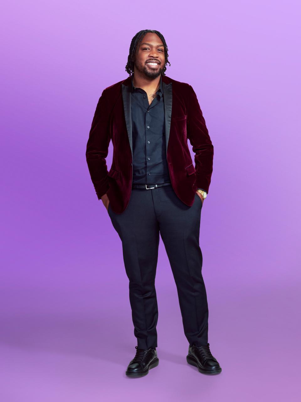 Kenneth, a contestant on "Love Is Blind" season 6, wearing a red jacket and black pants